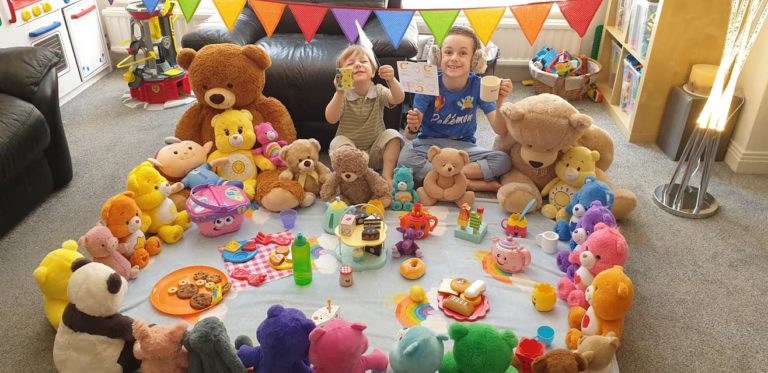 Two young fundraisers having a teddy bear's picnic