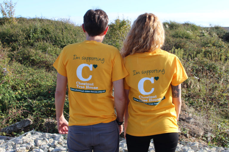 Two fundraising volunteers with CTH tshirts on