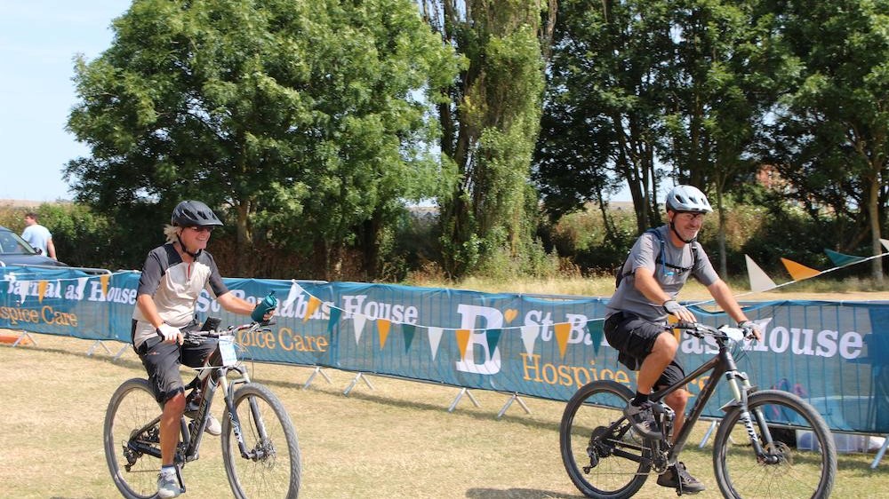Two cyclists at the Hit the Downs finish line