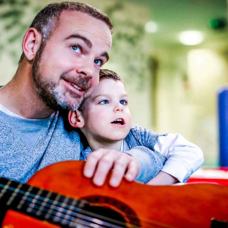 Father and Son playing guitar at Chestnut Tree House
