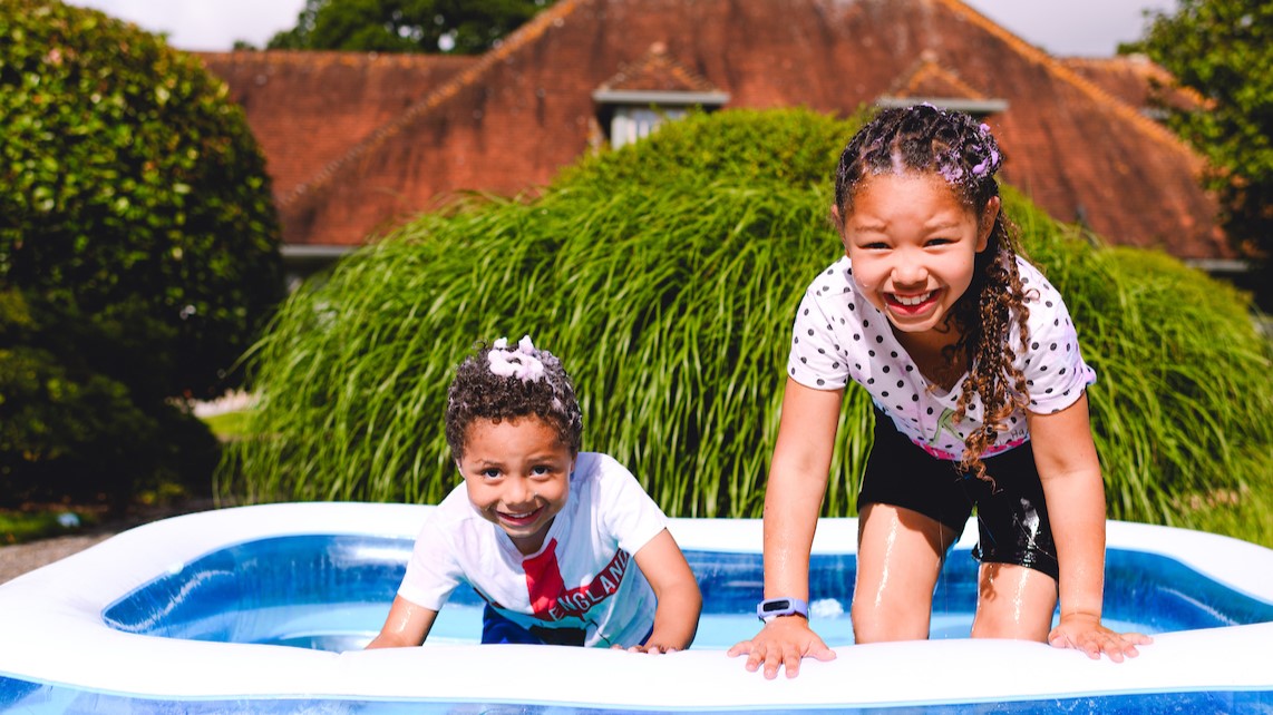 Children in paddling pool at the house