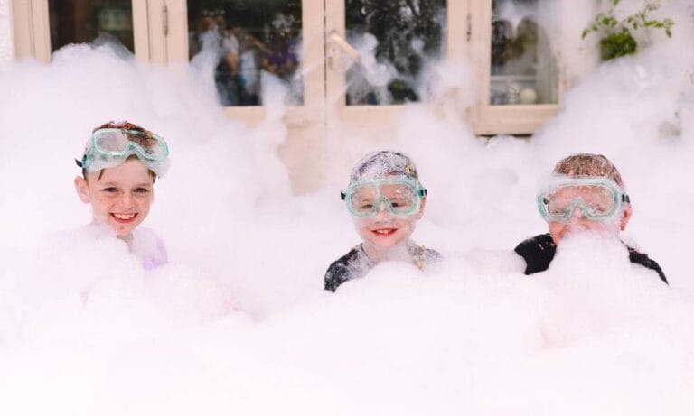 Image of Nora's sibling and friends in a huge bubble bath