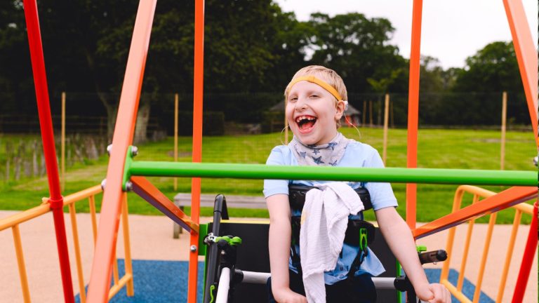 Image of Zac in his wheelchair on a special swing