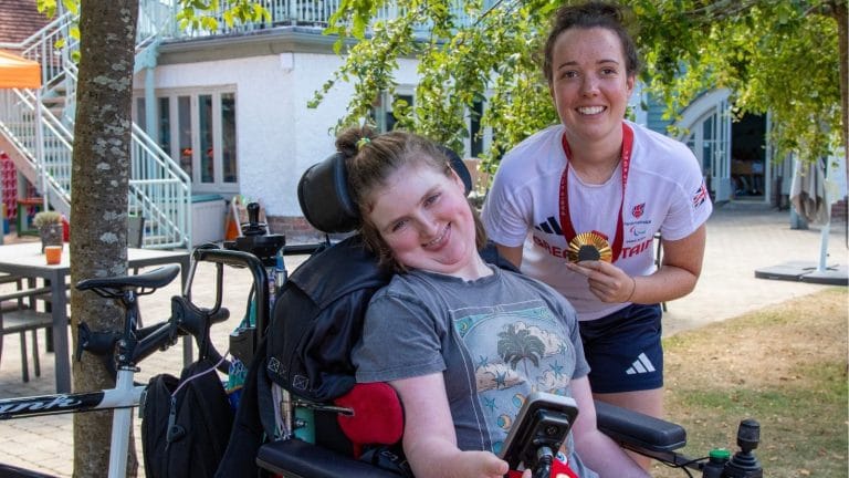 Charlotte smiling with Lizzie holding her gold medal
