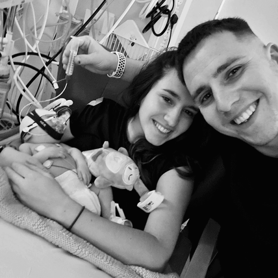 Zoe and Owen smile as she holds baby Loui