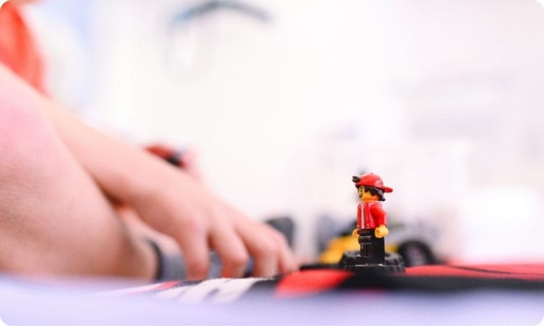A close up picture of a child playing with Lego