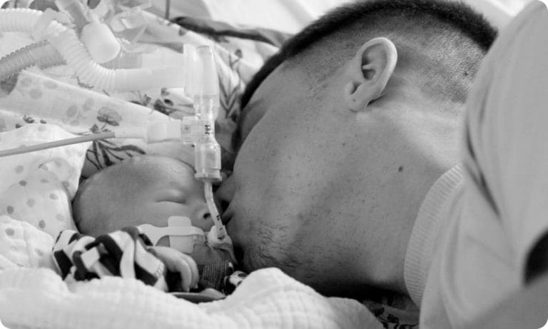 Owen kissing baby Loui's cheek