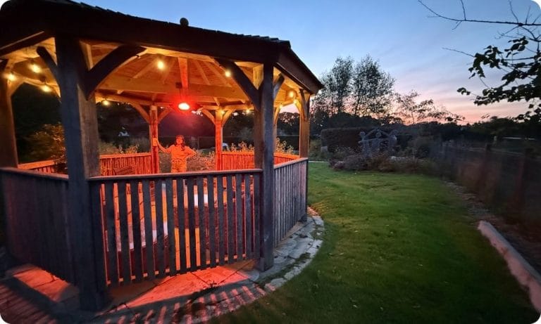 Mum Zoe sits in the pagoda fitted with lights and heating in Chestnut Memorial Garden