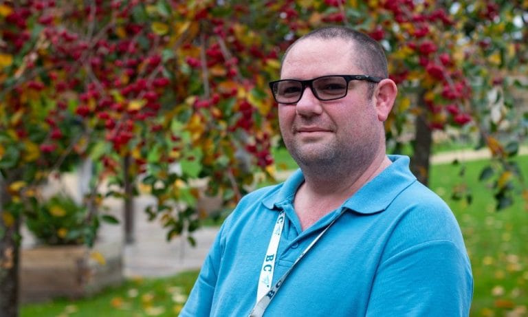Housekeeping assistant Martin is pictured in the gardens at Chestnut Tree House, where the trees are full of autumn colour.