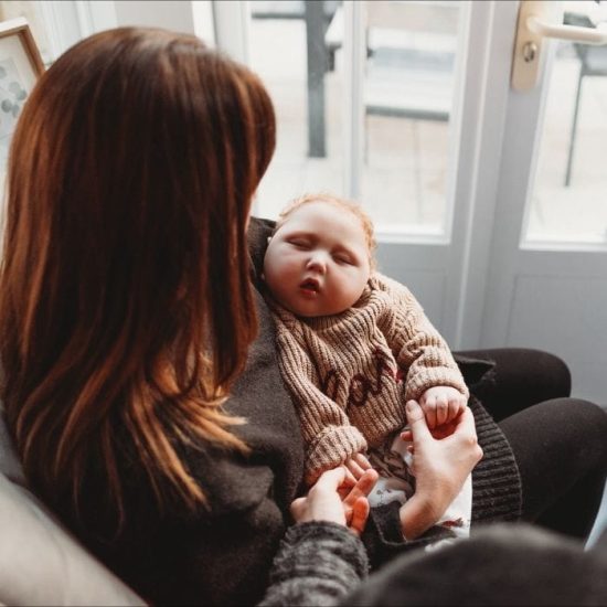 Lynsey cradles her son Raif as he sleeps in her arms
