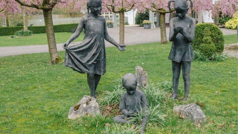 Three statues of children