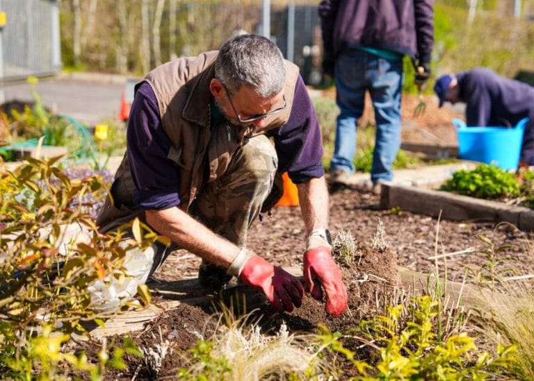 a volunteer working in the garden at one of our hospices